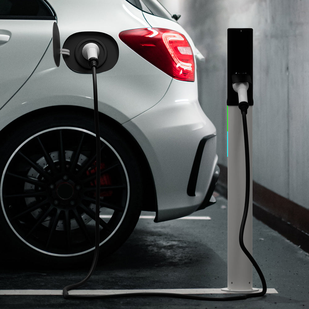 Electric car charging at a charging station in an indoor setting